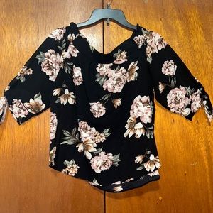 Woman’s black floral of the shoulder top.